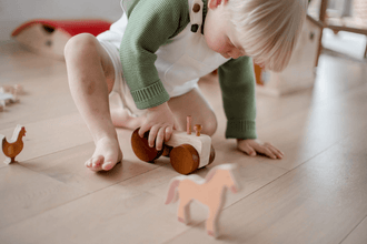 Wooden Farm Animals & Tractor Set detail playing with tractor - Learning Island